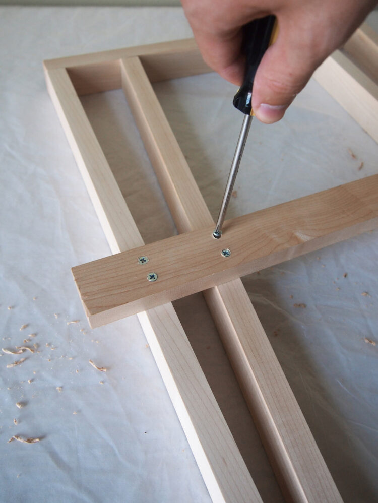 14     Hold the wood in place, drill holes and add two screws to secure the new 27.5in (70cm) piece.