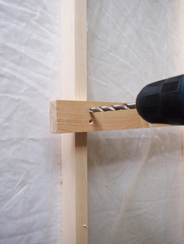 5     Hold both pieces steady and drill two vertical holes, evenly spaced. Then countersink the holes (do this by drilling very shallow holes, the width of the screw head, in the first holes).