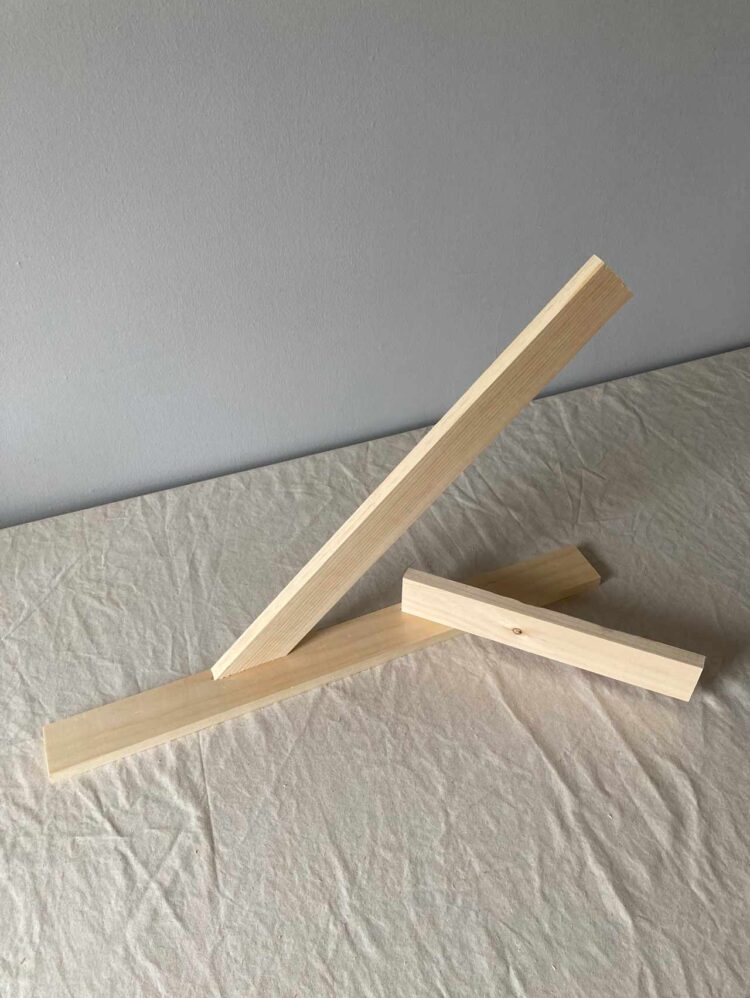 16     Align the bottom of a 14in (35.5cm) long piece of wood at that mark at a 45 degree angle. Join the two pieces with 2 dowel pins and glue.