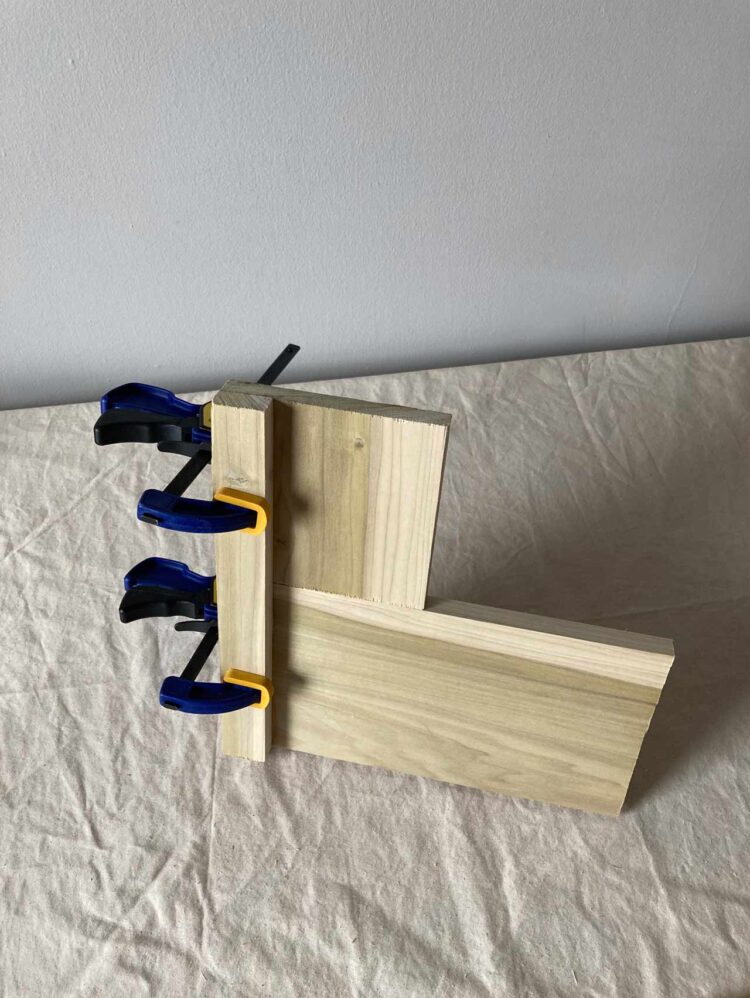 4     Glue and clamp wood pieces together to make a roughly 13.5in x 13.5in x 1.5in (35cm x 35cm x 4cm) piece.